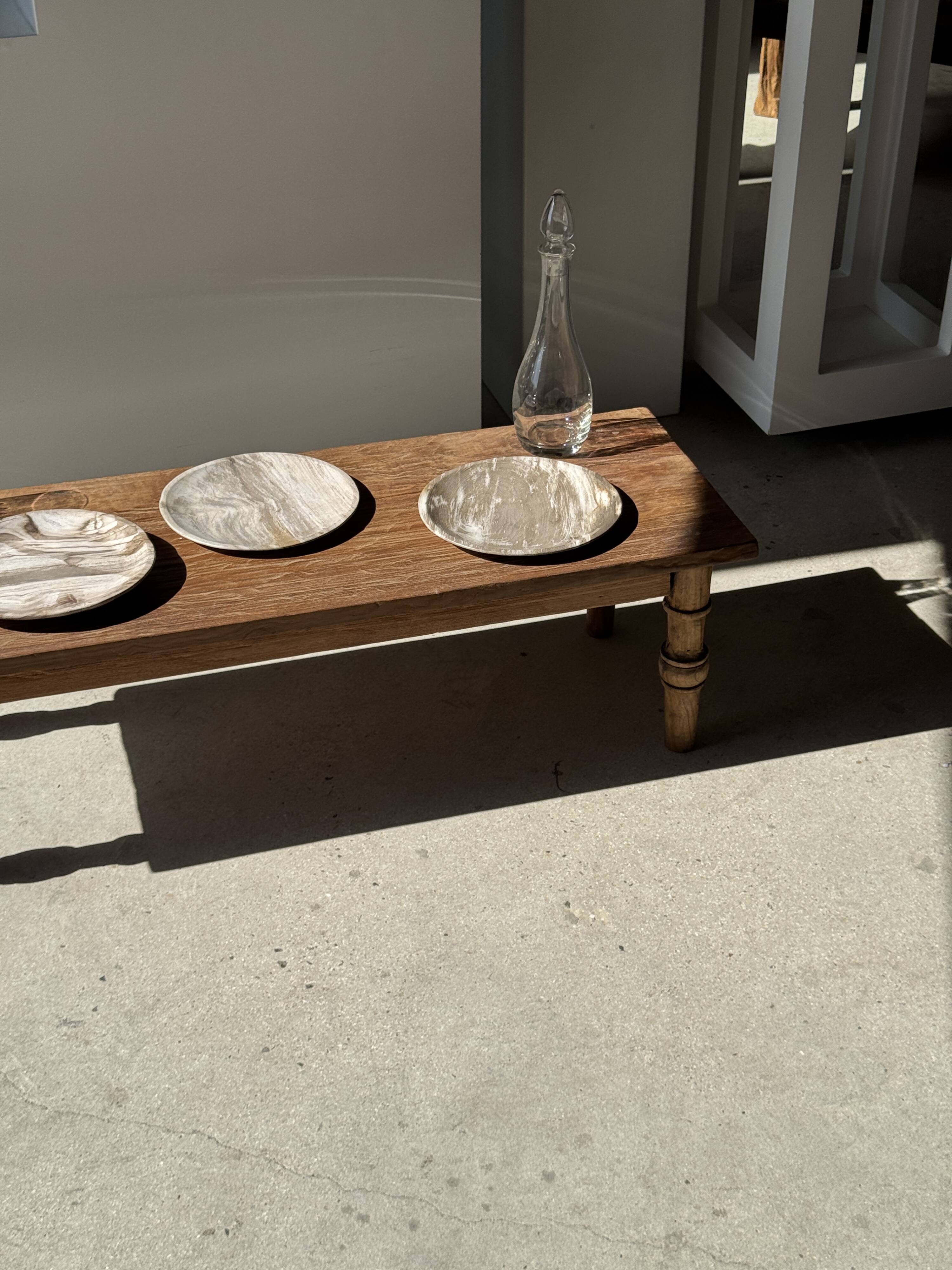 Tray, circular dish or plate made of white striped grey petrified wood.