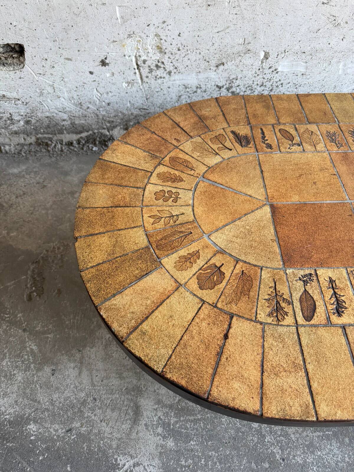 Roger Capron brown-ochre ceramic tile coffee table with wooden base, oval leaf-motif top