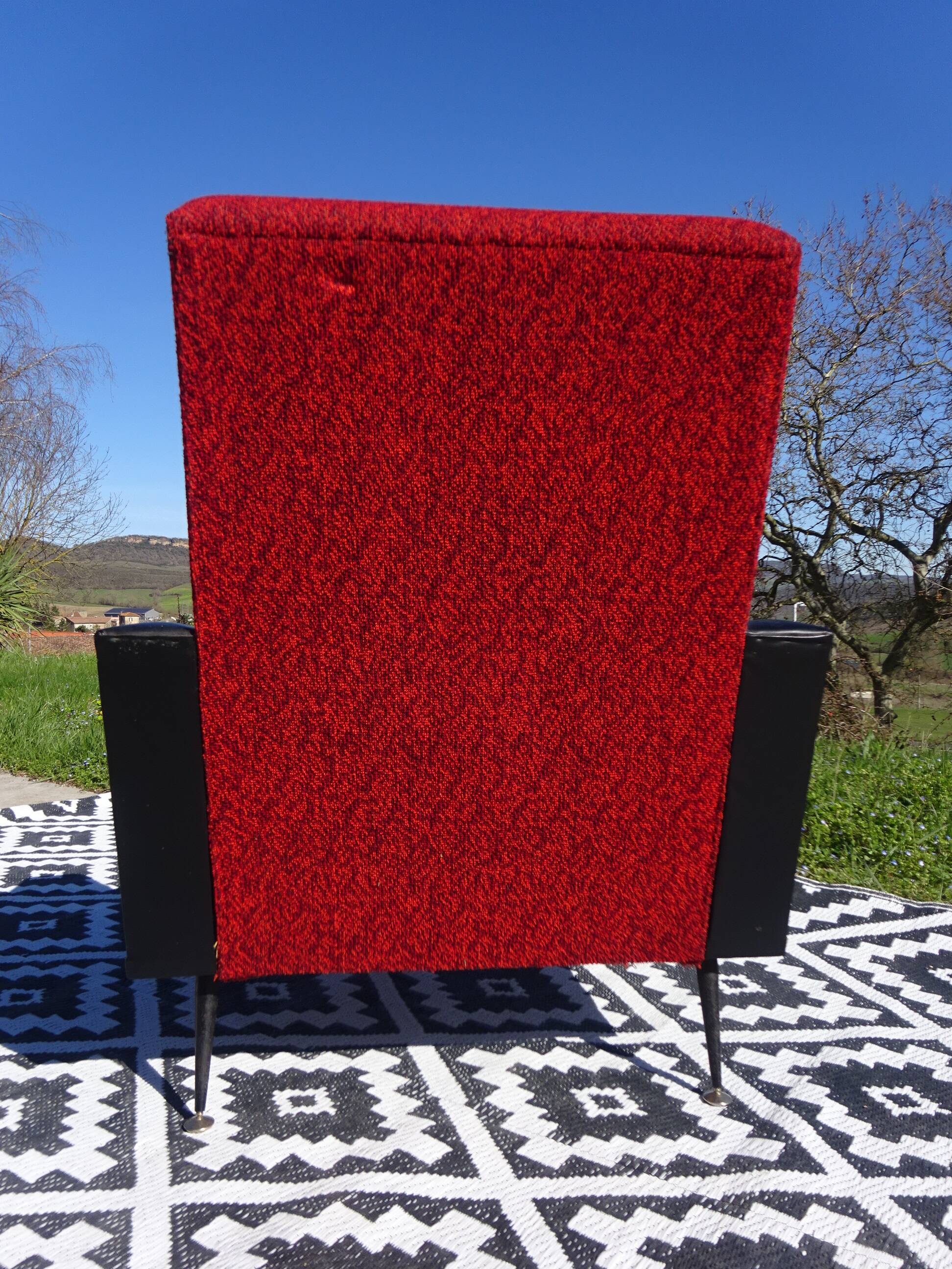 Vintage armchairs in red and black faux leather, the pair.