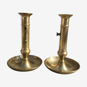 Pair of old brass pusher candle holders