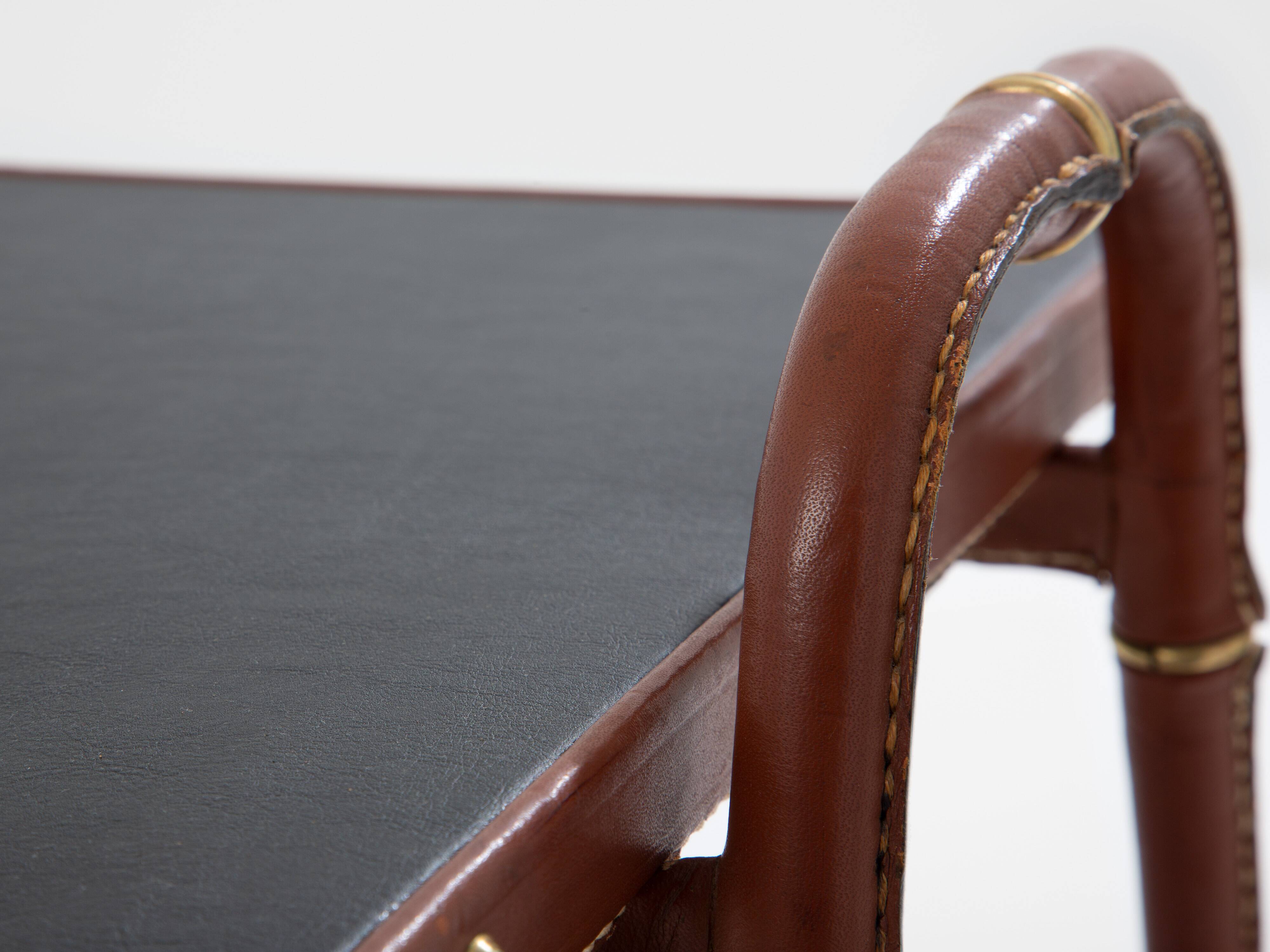 Jacques Adnet coffee table in red saddle-stitched leather and brass, 1950s