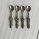 Antique small spoons with a metal bow design