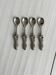 Antique small spoons with a metal bow design