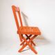 Vintage folding chair in orange painted wood