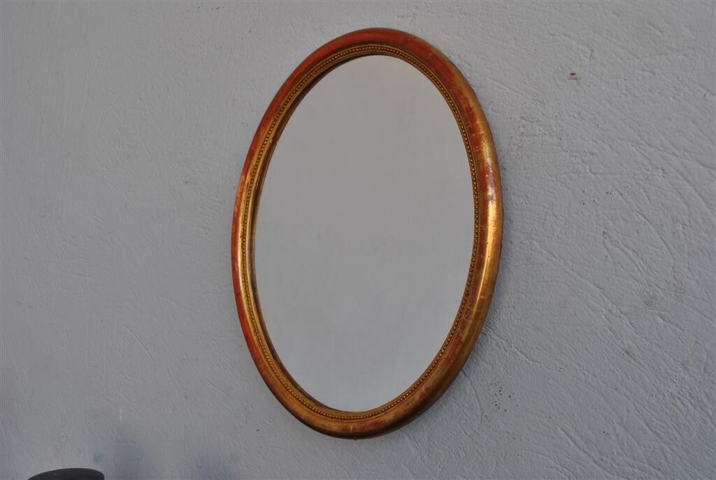 Golden stucco oval mirror