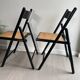 Vintage folding chairs in black wood and cane.