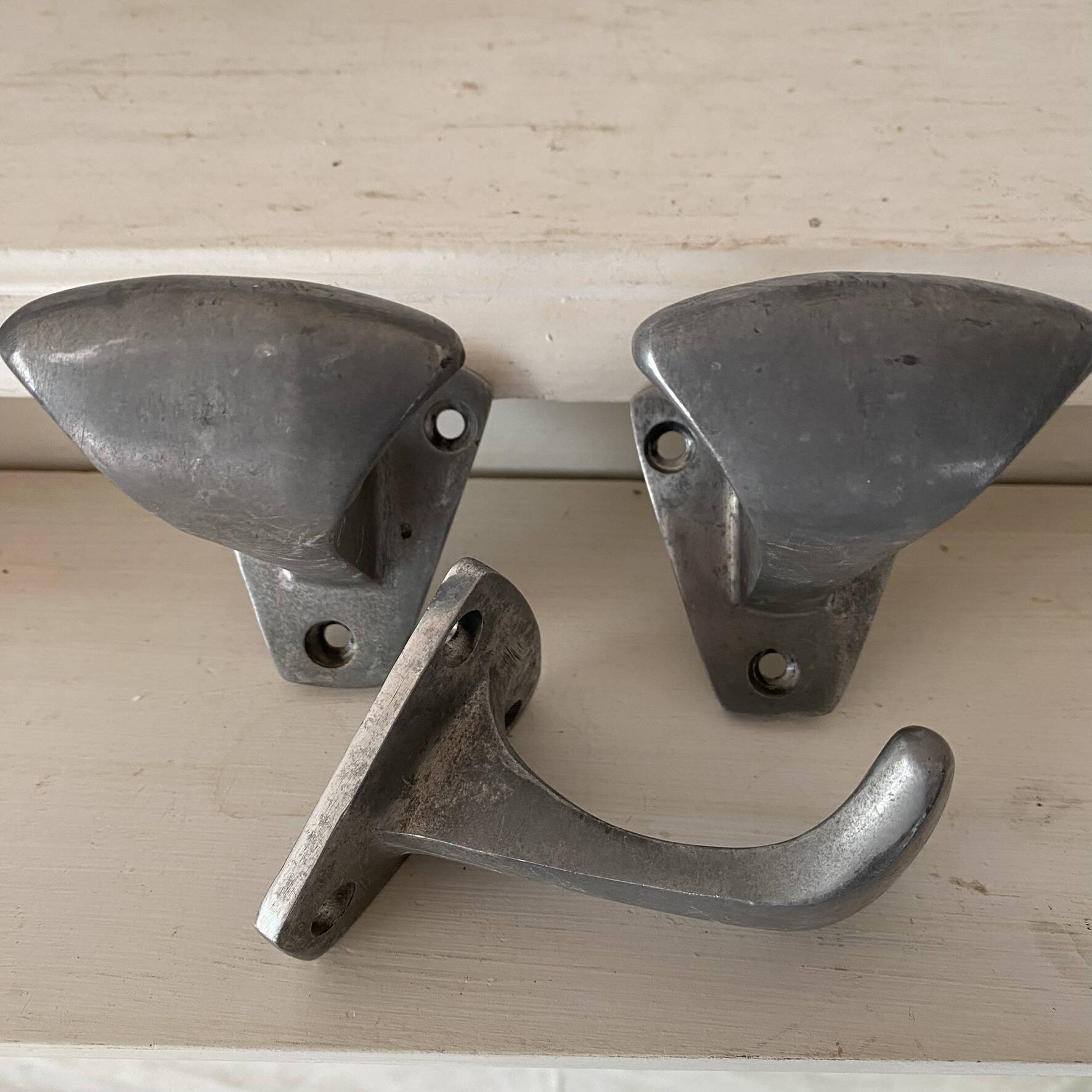 Set of 3 vintage steel hooks from a school.