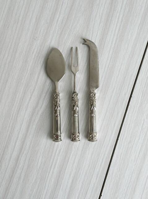 Antique shiny metal cheese cutlery