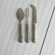 Antique shiny metal cheese cutlery
