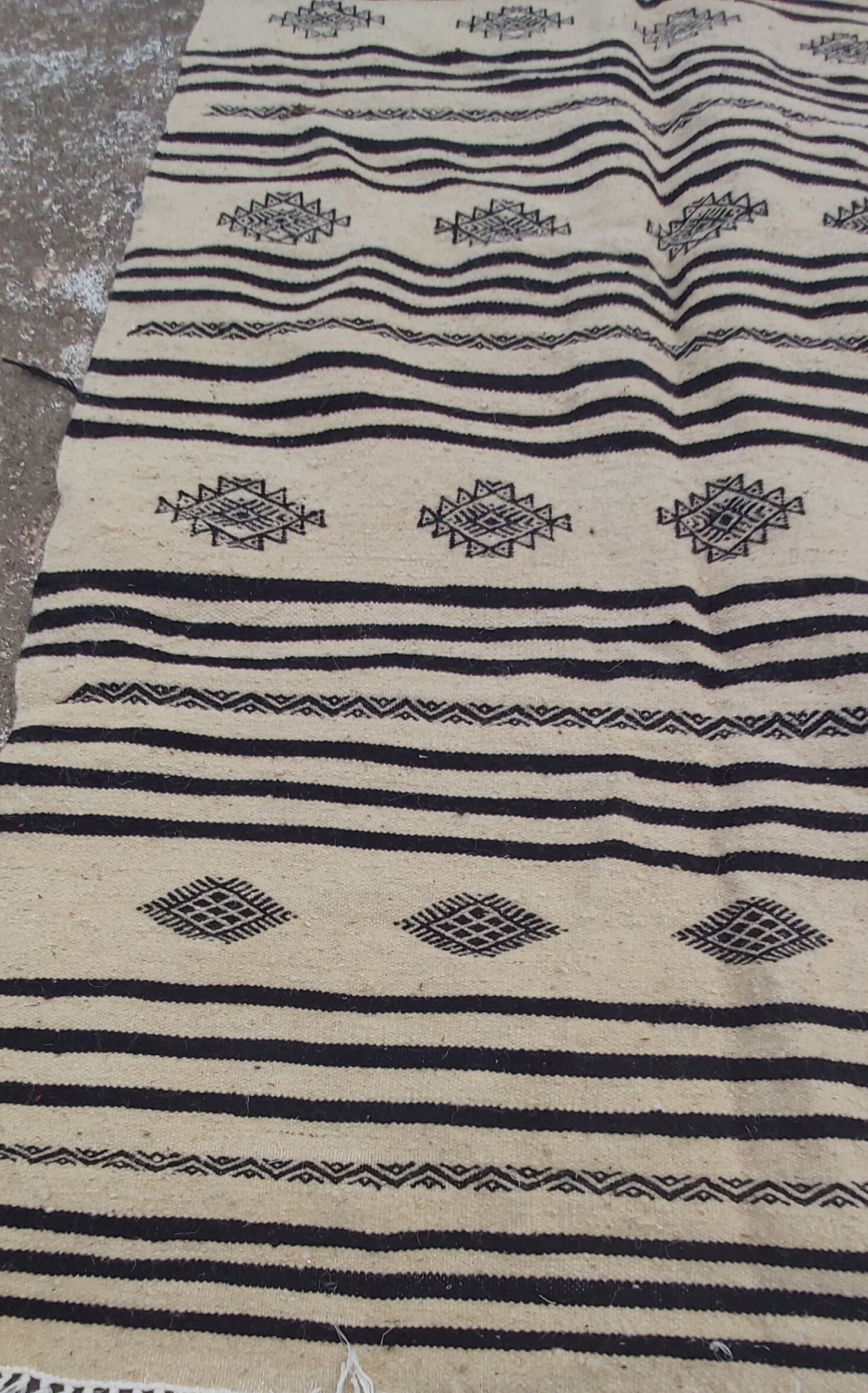 Traditional hand-woven beige and black carpet
