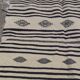 Traditional hand-woven beige and black carpet