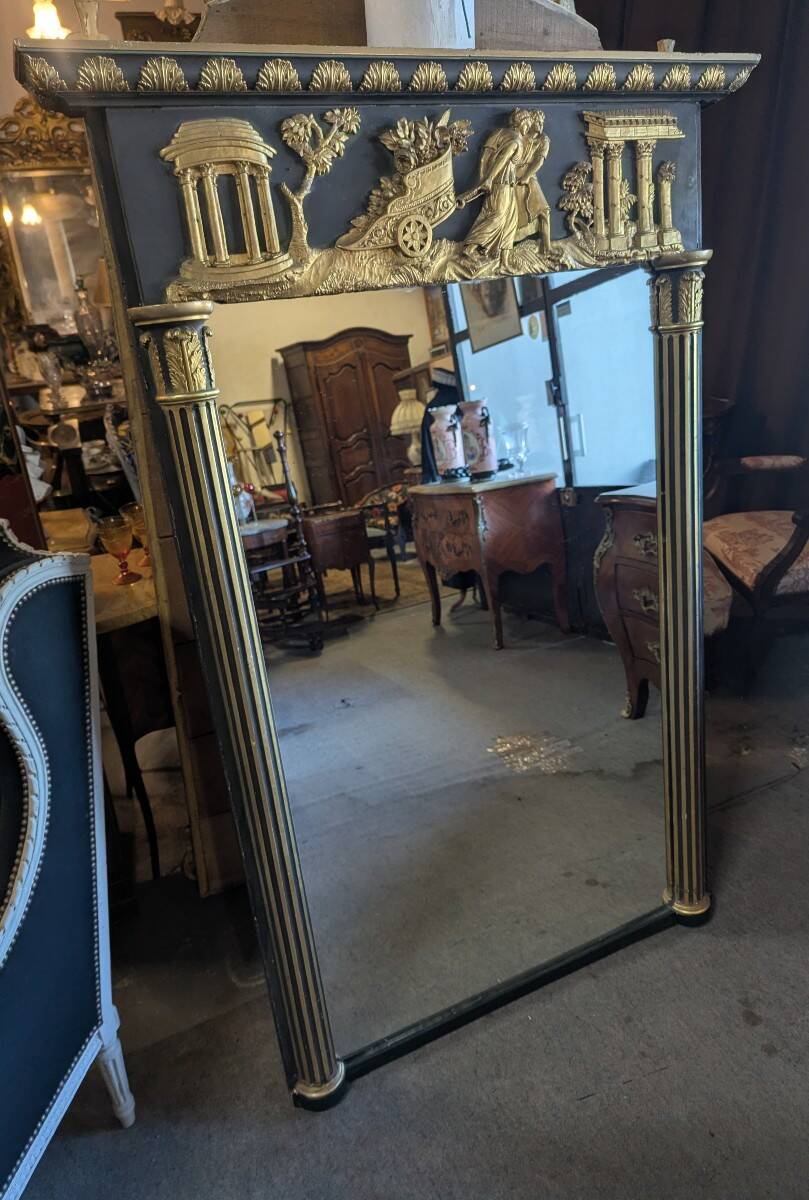 Large Empire-style mirror in dark green painted wood and gilded stucco.