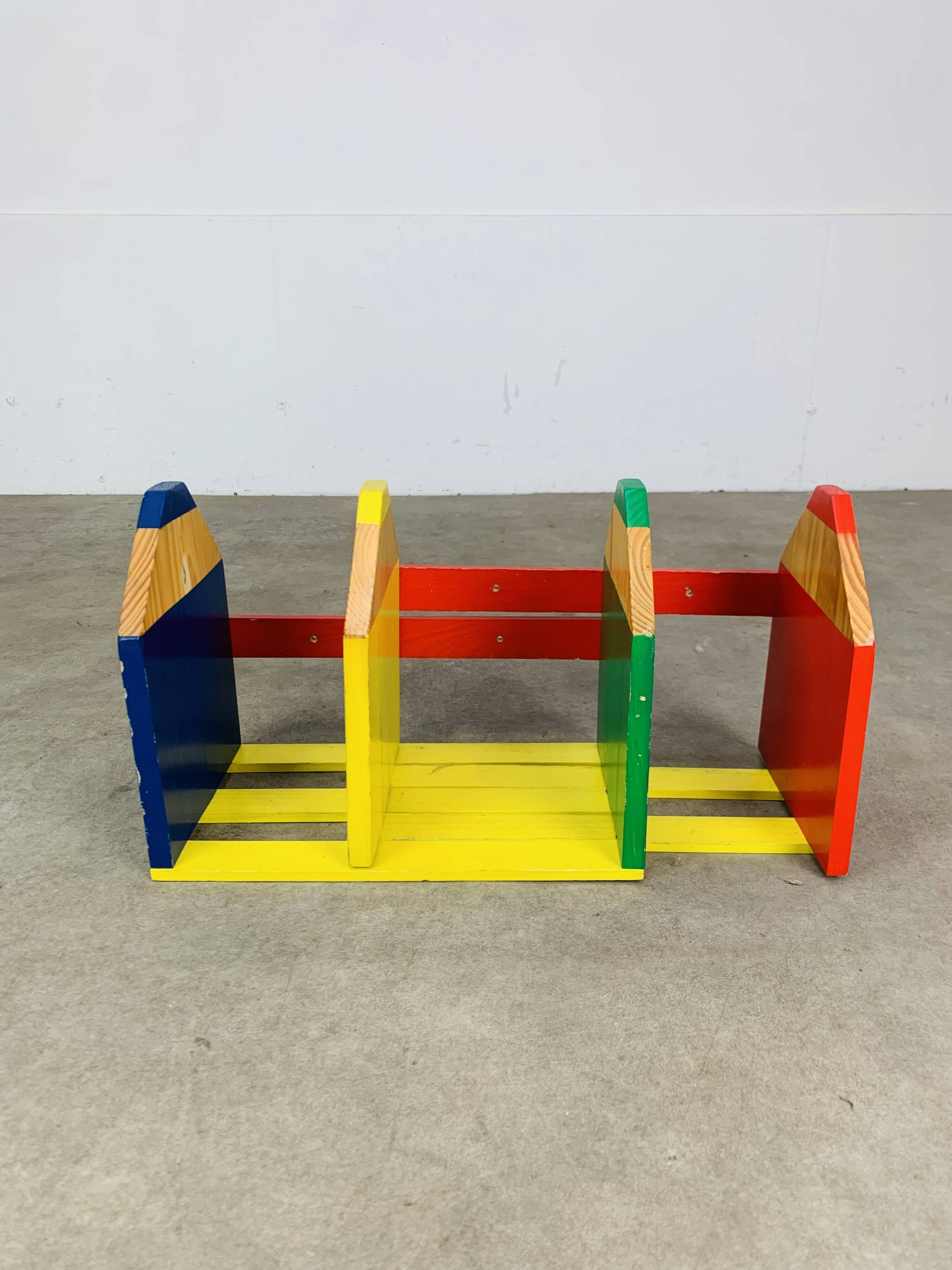 Modular wall-mounted pencil shelf in Pierre Sala style, for children.