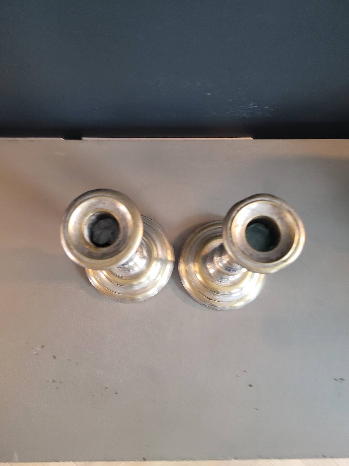 Paire de bougeoirs anciens en laiton argenté