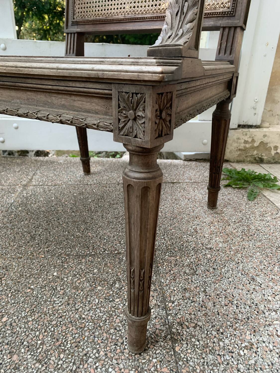 Wooden armchair with caning in Louis XVI style