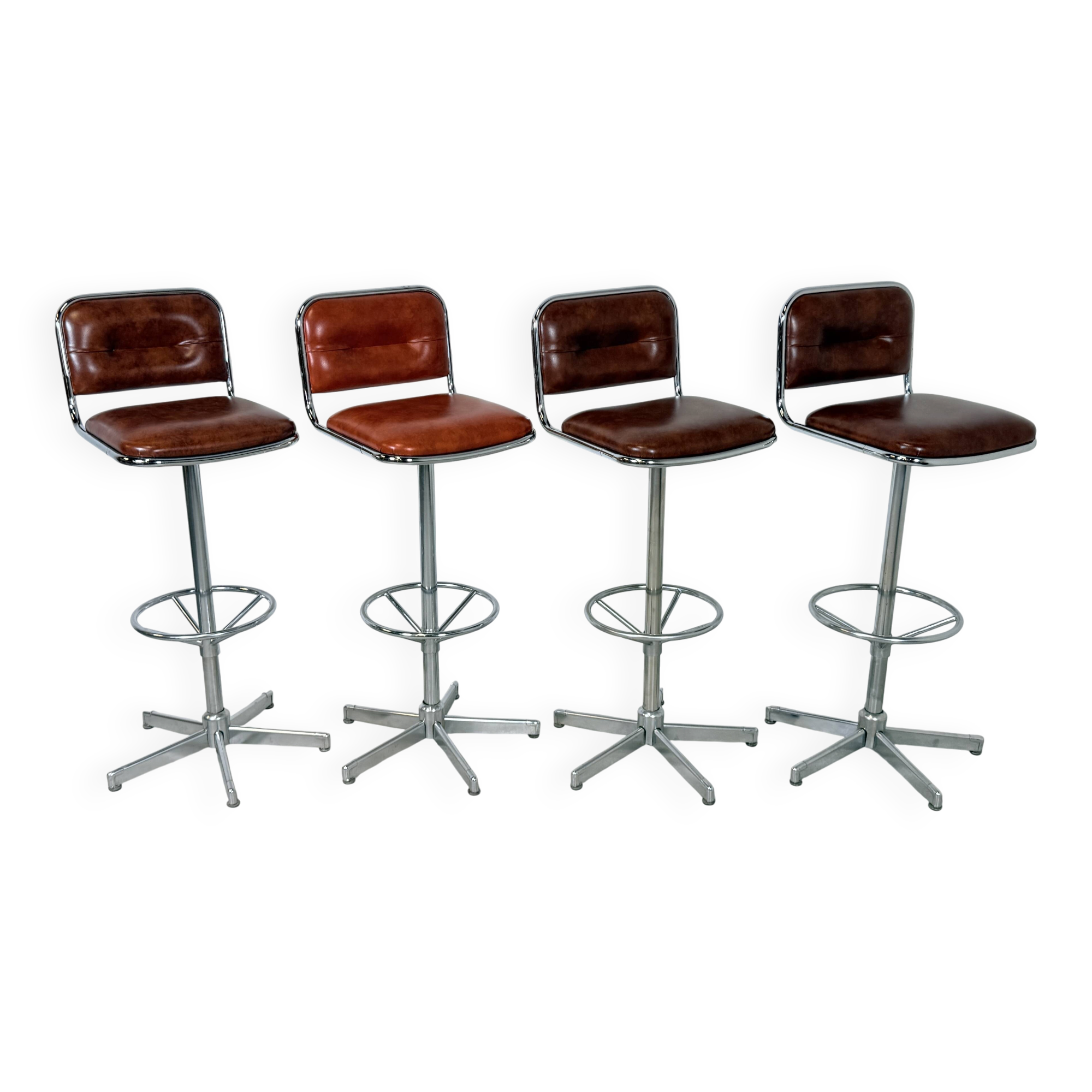 1970s chrome bar stools with cognac-colored faux leather upholstery