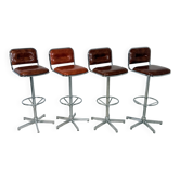 1970s chrome bar stools with cognac-colored faux leather upholstery