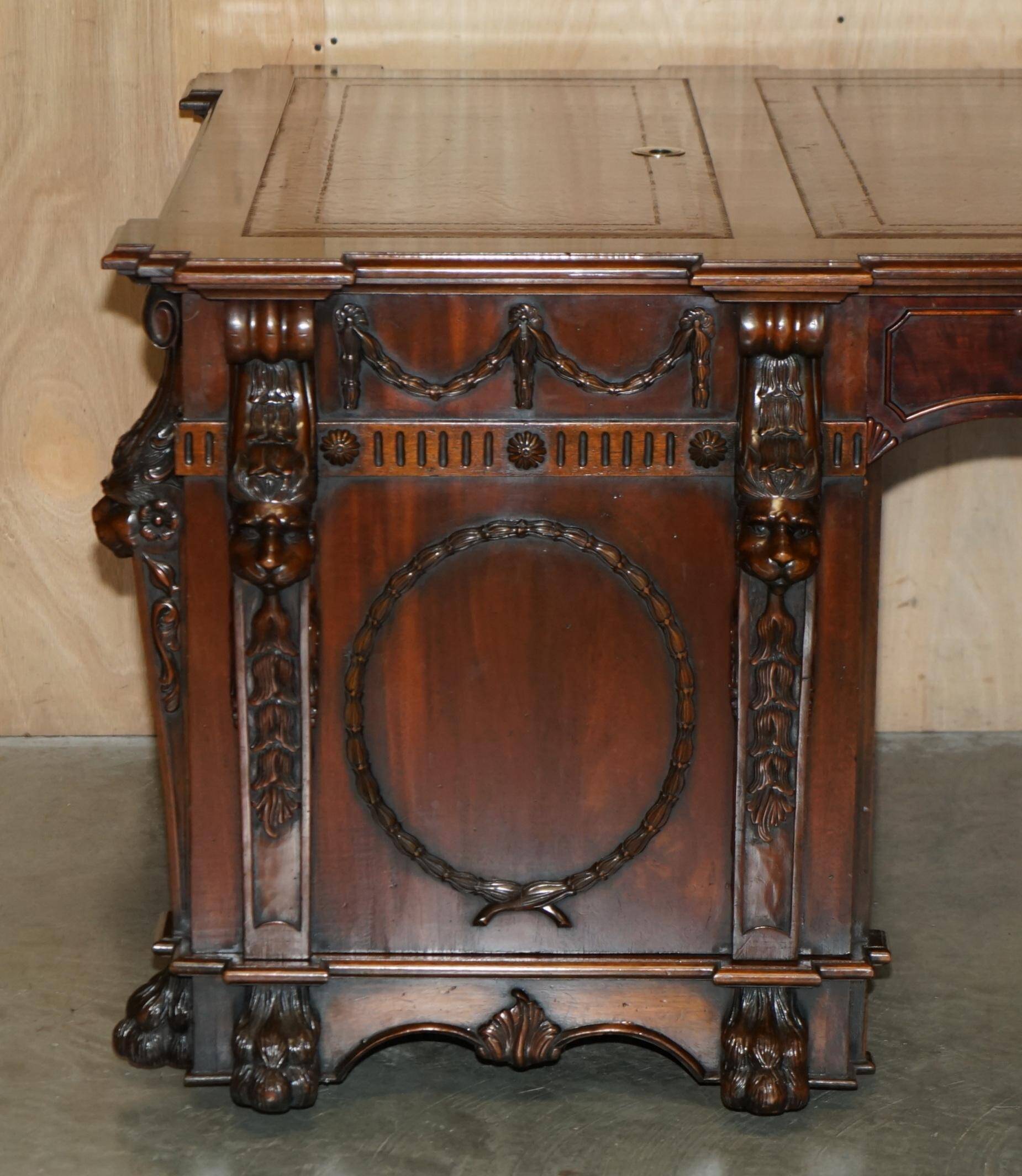 Partner desk with two carved columns featuring lion heads, according to Thomas Chippendale, restored.