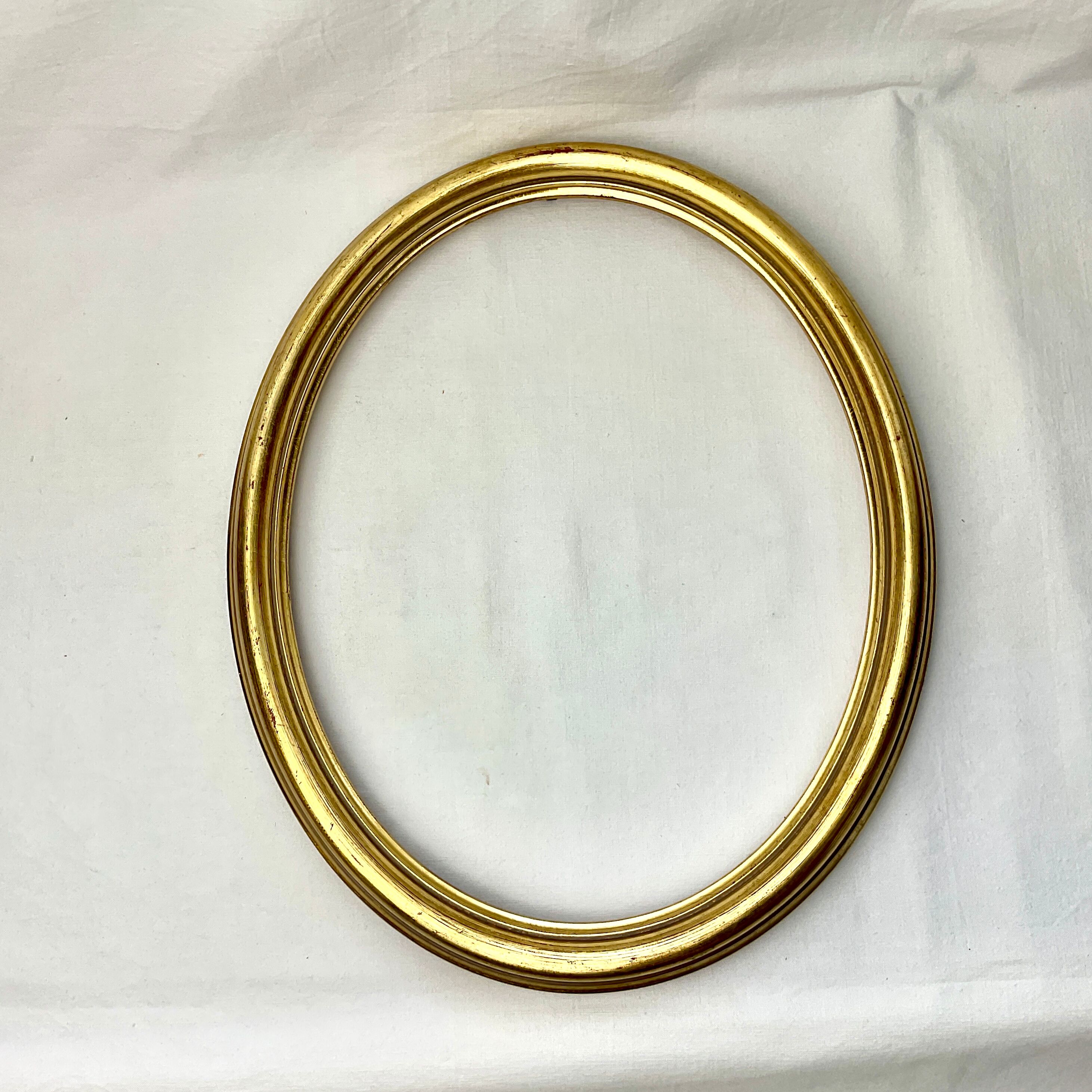 Old oval gilded wooden frame with domed glass
