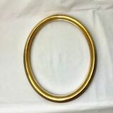 Old oval gilded wooden frame with domed glass