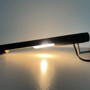 Minimalist black metal wall light with a cylindrical design, 1960s, Germany.
