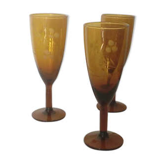 3 champagne flutes in colored glass