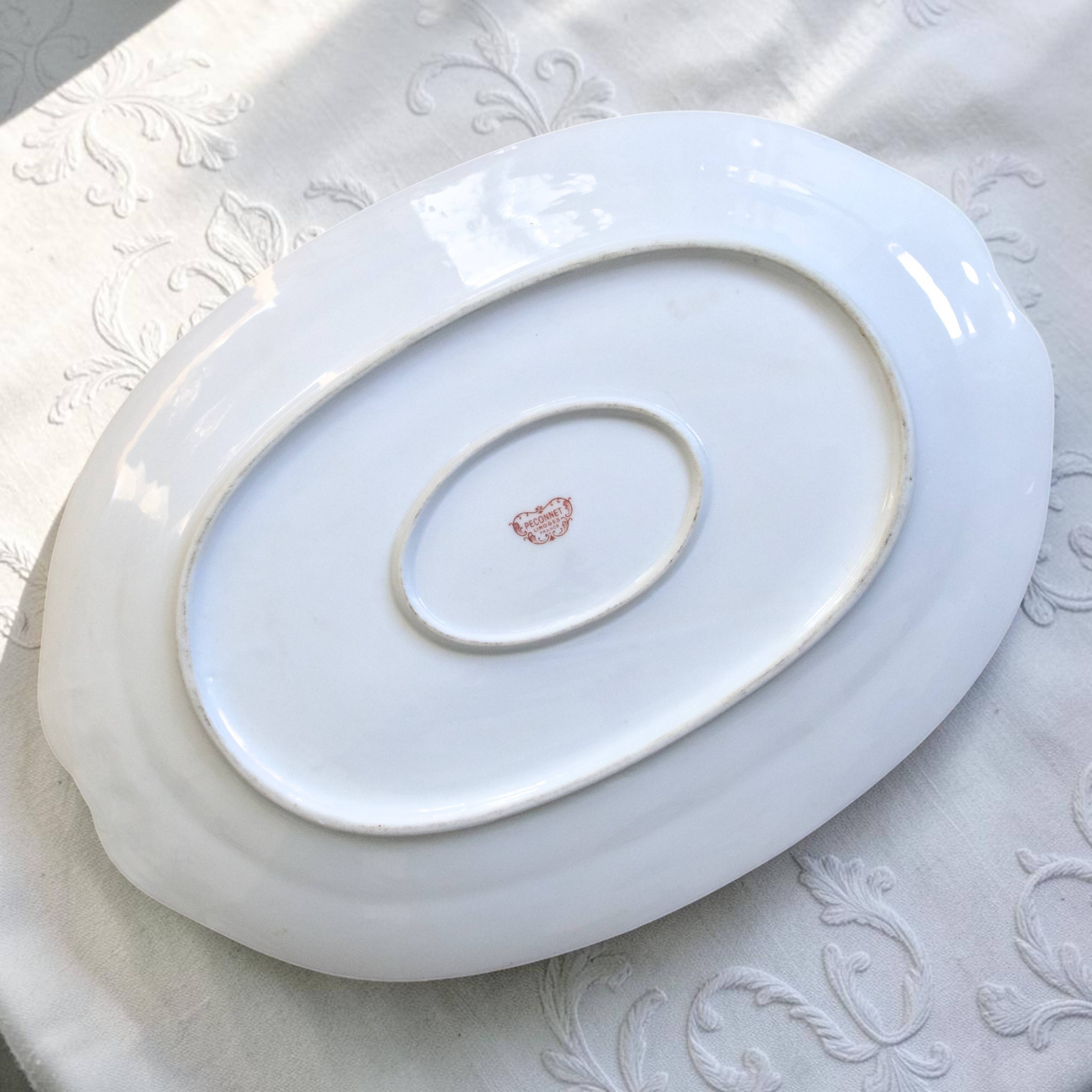 Very large oval dish with gold trim in Limoges porcelain by Peconnet.