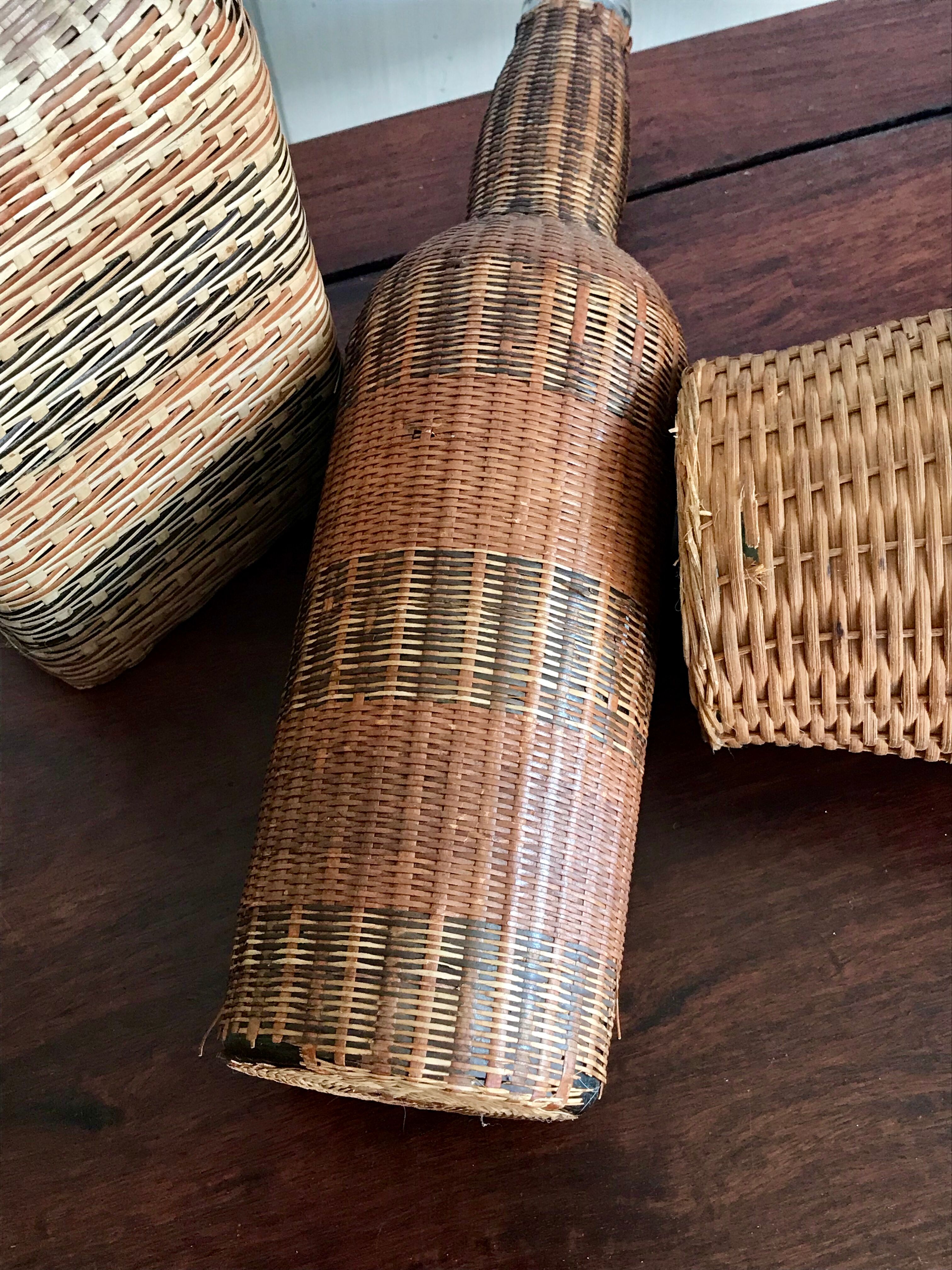 Set of three vintage rattan bottles