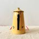 Old coffee maker in yellow enameled sheet metal - olive decor
