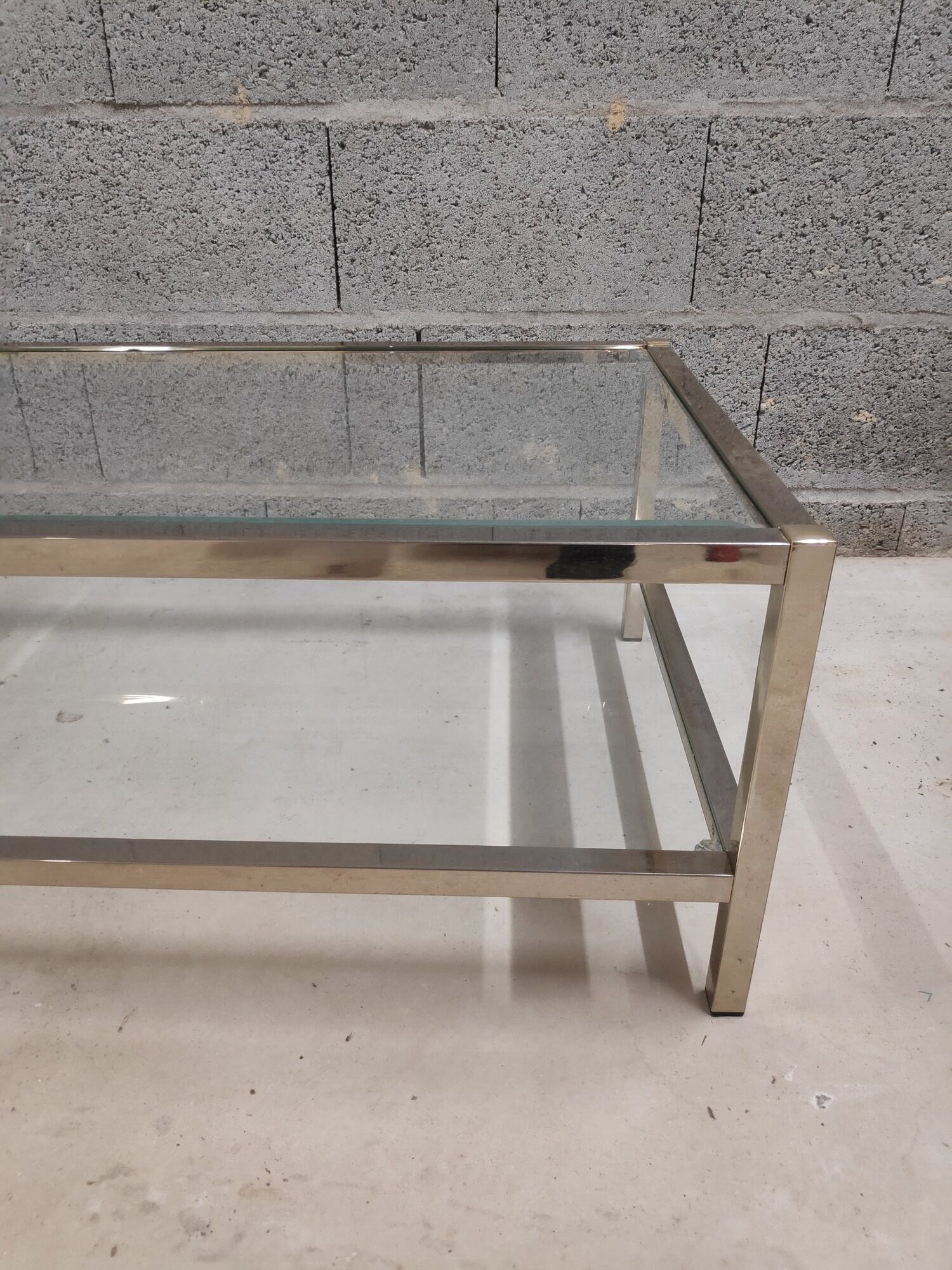 Vintage bevelled glass coffee table and lightly gilded square metal tubes from the 70s/80s