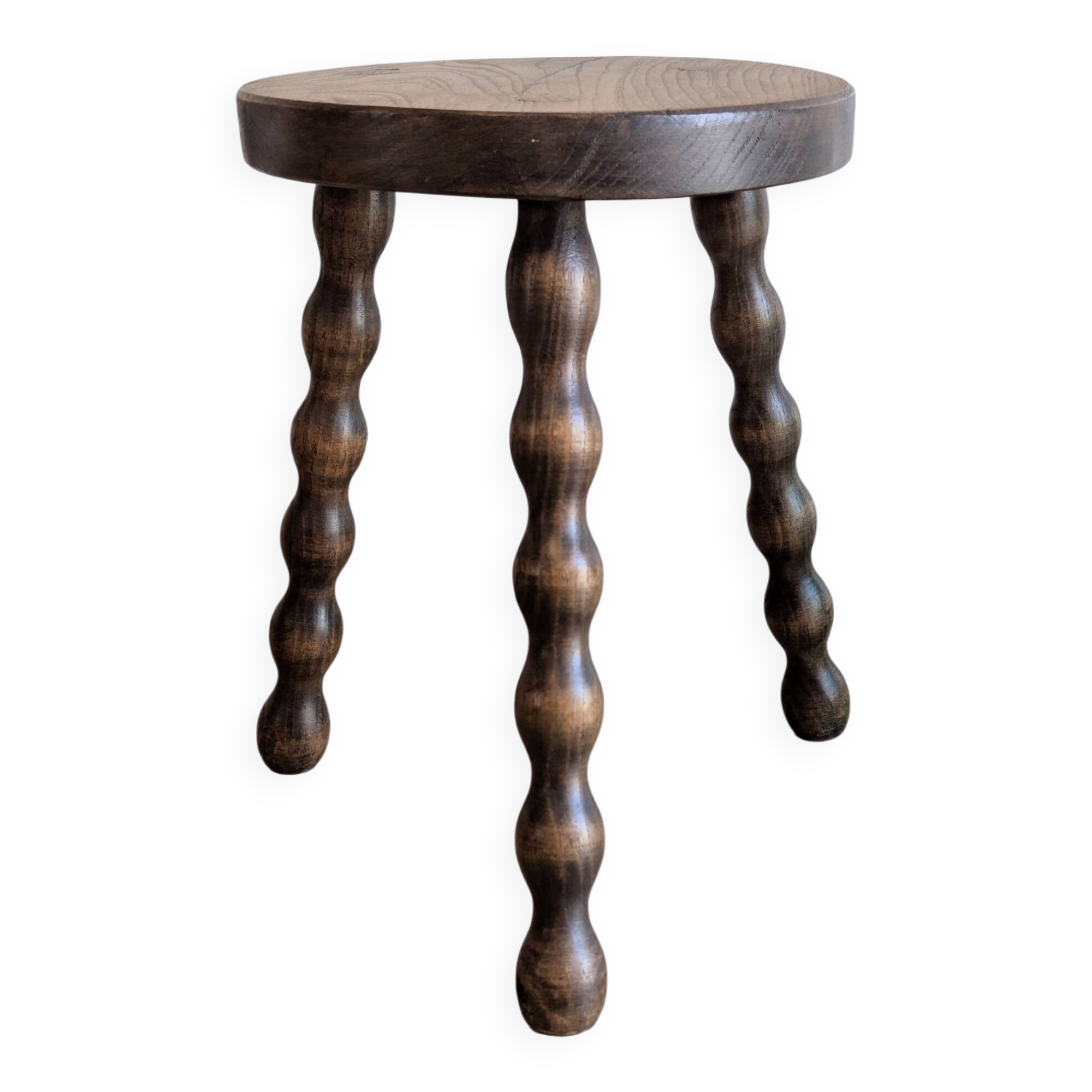 Small wooden tripod stool with turned legs, country style.