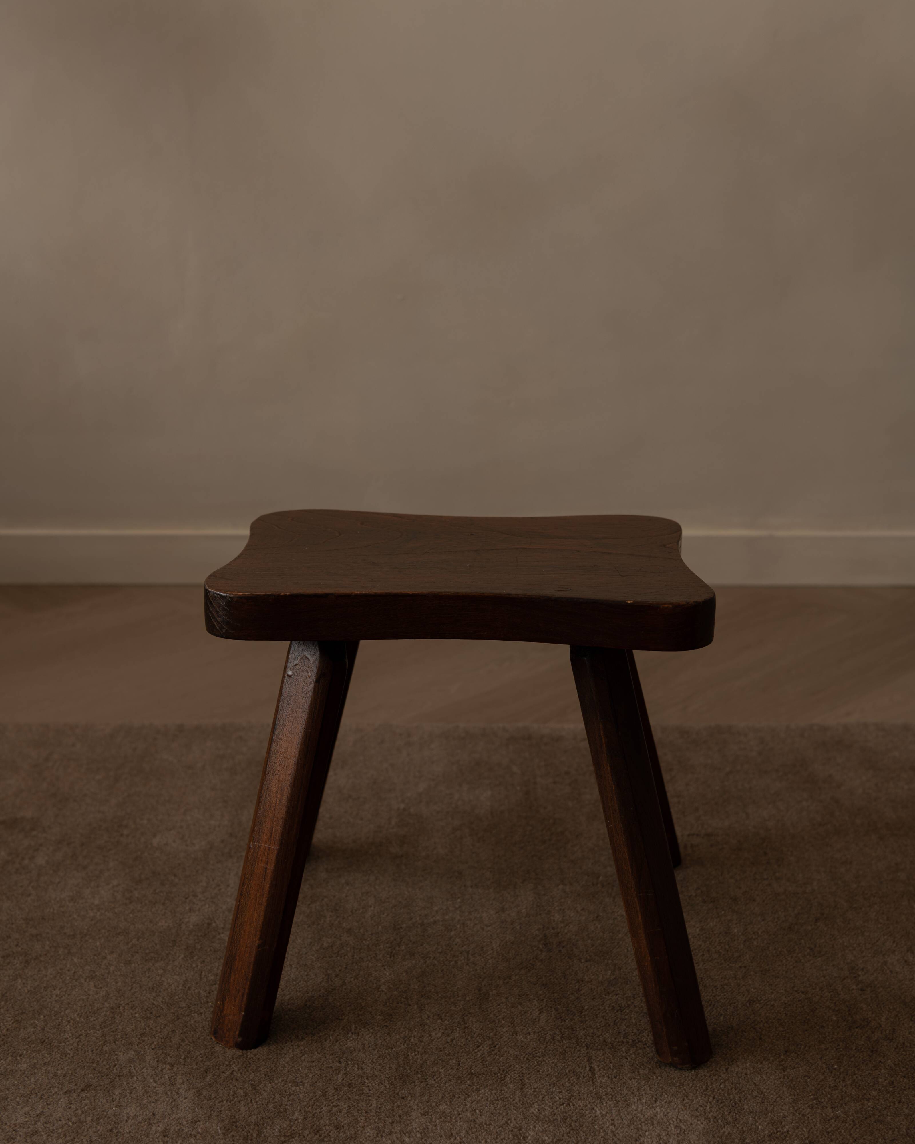 Vintage wooden stool in organic shape