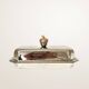 Silver-plated butter dish with a hazelnut knob.
