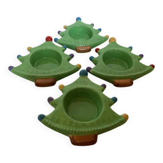 Four Christmas tree-shaped candle holders