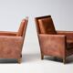 Pair of Art Deco armchairs in brown leather and teak, Netherlands, 1970s.