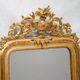 Louis-Philippe mirror from the 19th century with vase and crown of flowers.