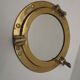 Mirror integrated into a brass navy porthole