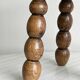 Small three-legged stool made of turned wood.