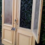 Porte d'entrée cintrée double en chêne, grilles et verre, XIXème