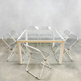 Plia' chairs by Giancarlo Piretti for Castelli with a table