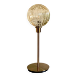Table lamp with a gold striped globe and a gold foot