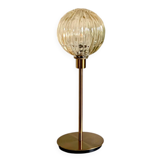 Table lamp with a gold striped globe and a gold foot