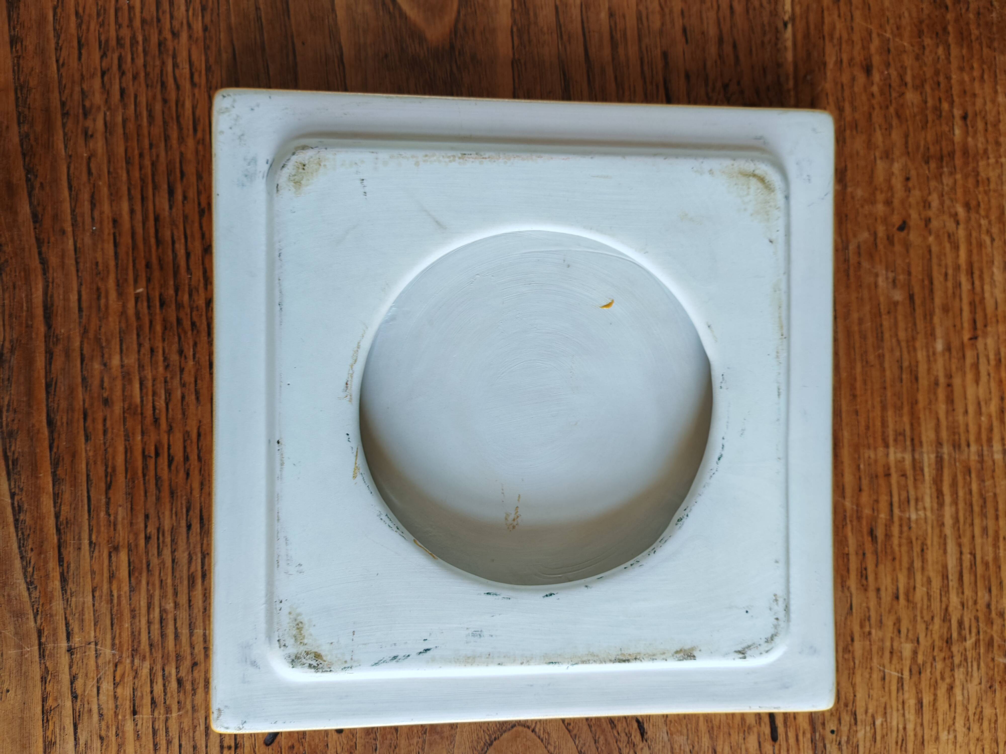 Yellow glazed ceramic trivet signed l. drimmer