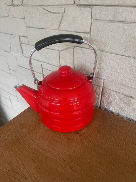Old red enameled kettle