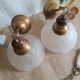Pair of frosted glass flower pendant lights with vintage wood and brass
