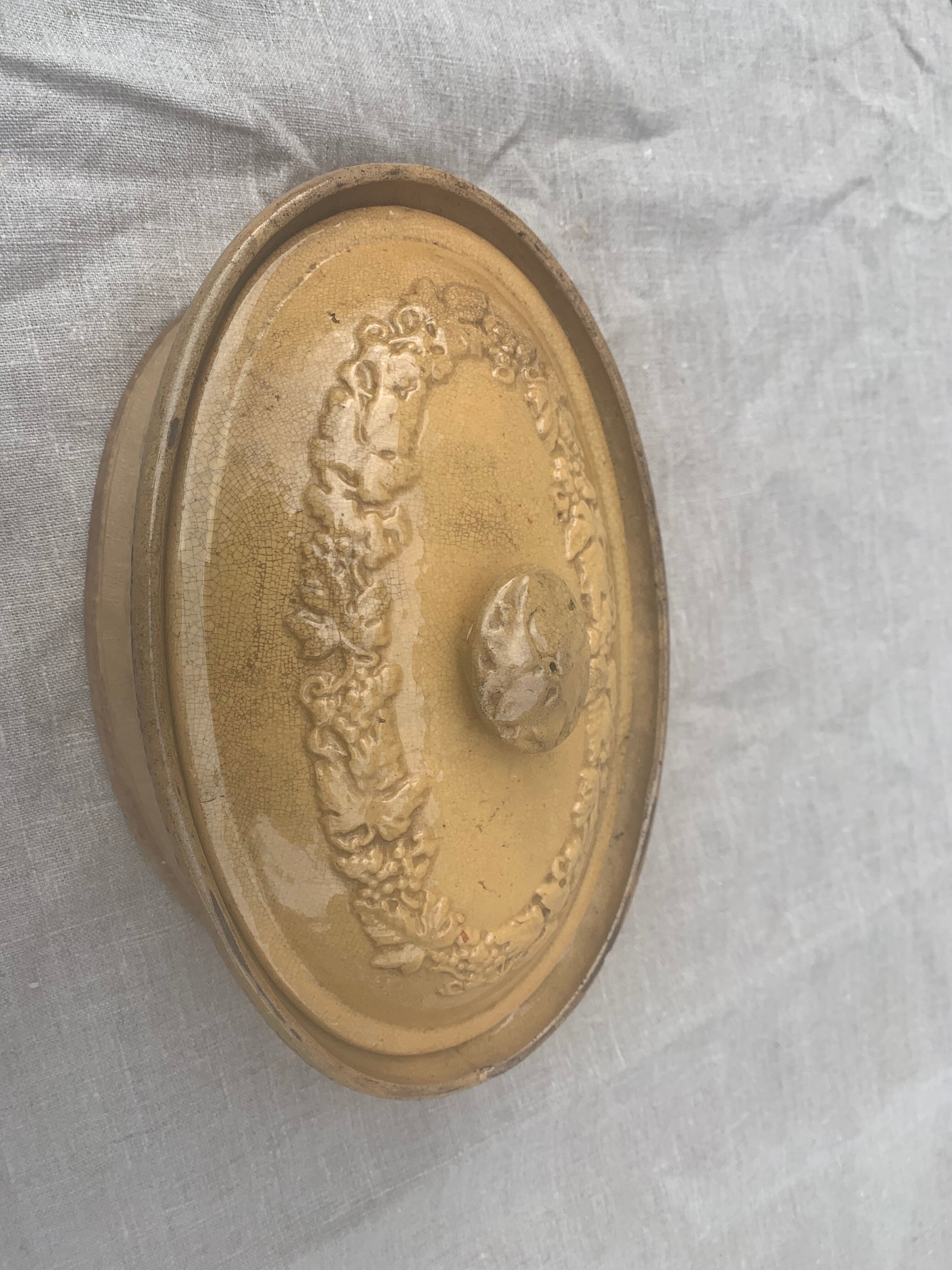 Old terrine in glazed stoneware and floral decoration mustard yellow slip