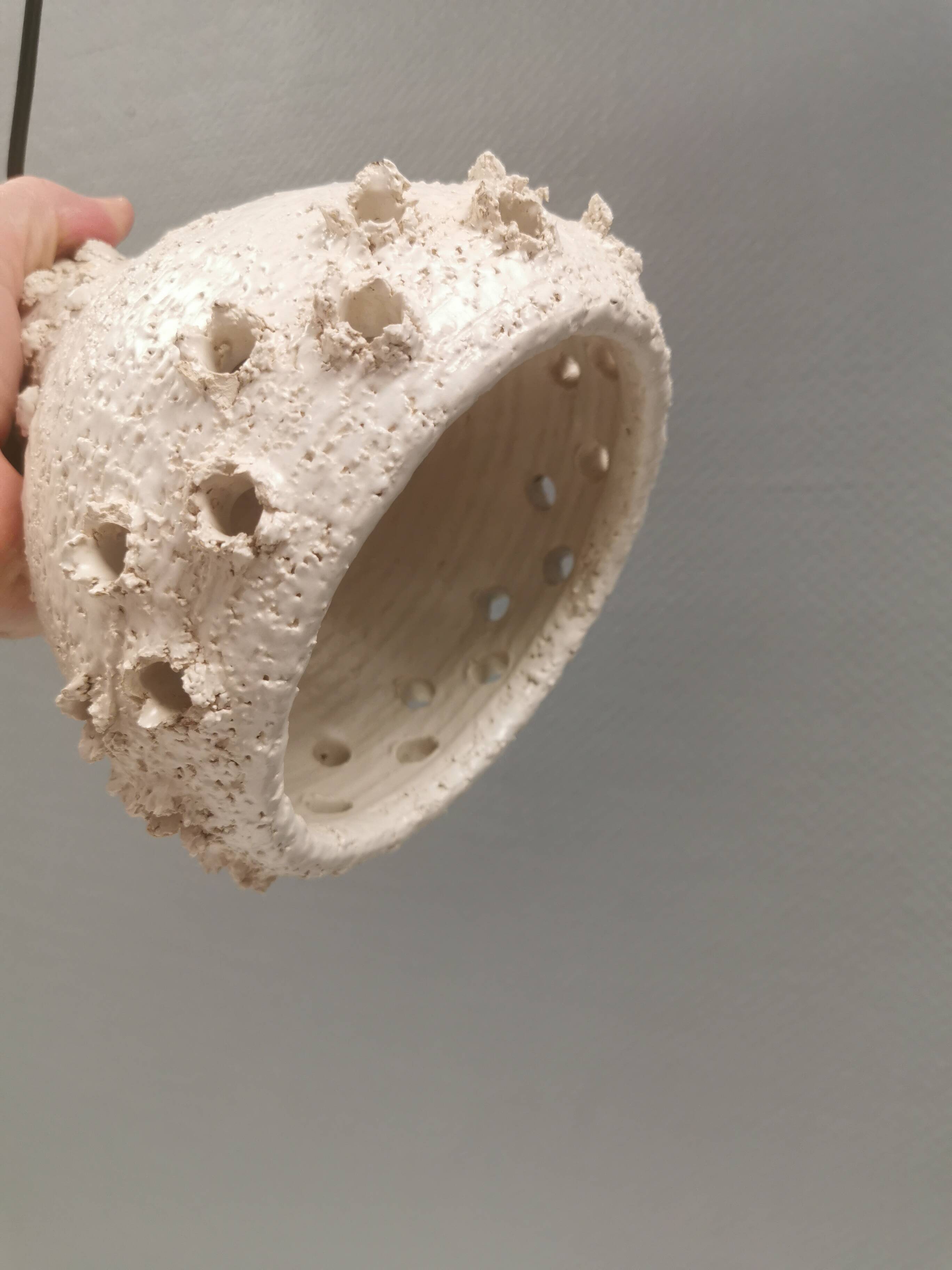 Ceramic hanging lamp in creamy white color that almost looks like a corral