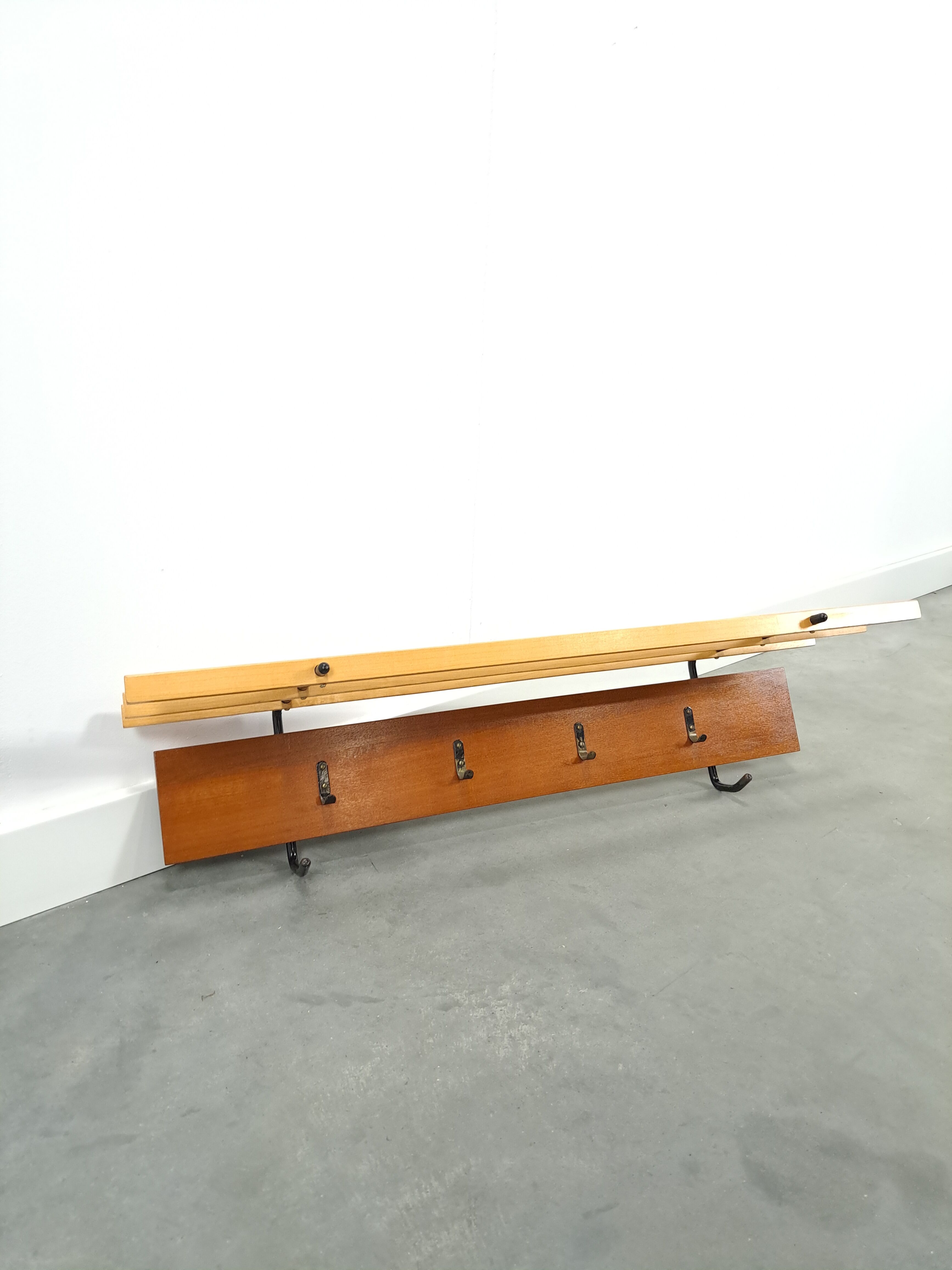 Vintage wall coat rack with black hooks and light wood