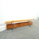Vintage wall coat rack with black hooks and light wood