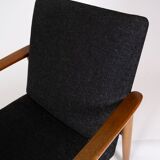 Easy chair with stool in teak and dark wool fabric of danish design from the 1960s.